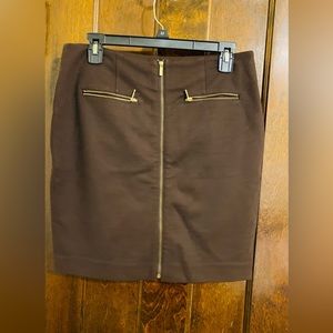 Brown skirt with gold zippers.